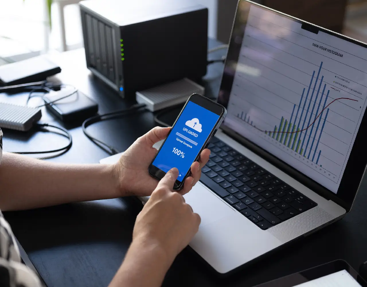 Person using phone and laptop for data