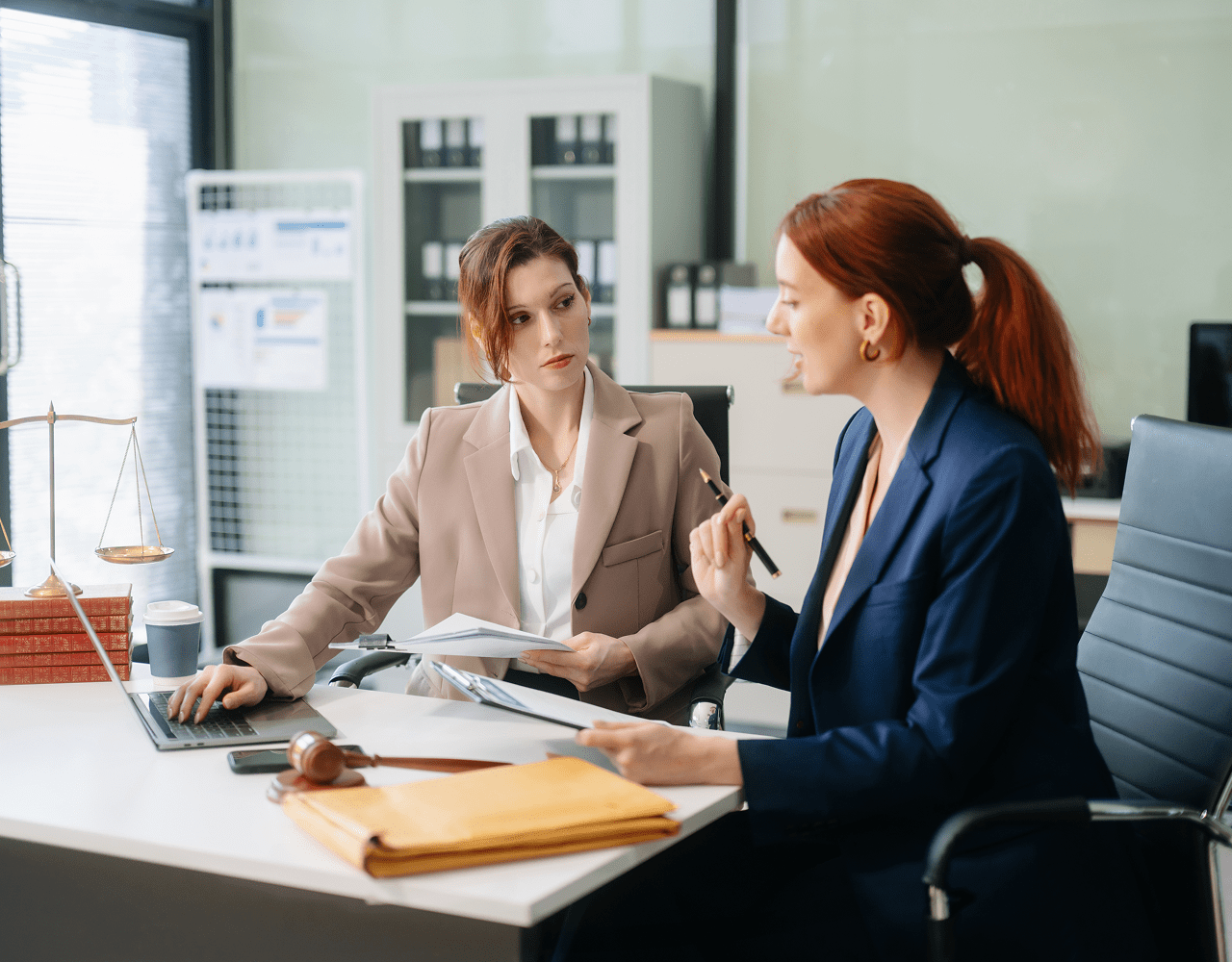 Business conversation with documents and laptop